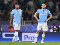 Mateo Kovacic (right) and Manuel Akanji (left) of Manchester City react after Maxi Araujo of Sporting CP scores his team's second goal durin...