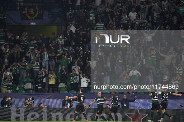 Viktor Gyokeres of Sporting CP celebrates with his teammates after scoring his team's third goal during the UEFA Champions League match betw...