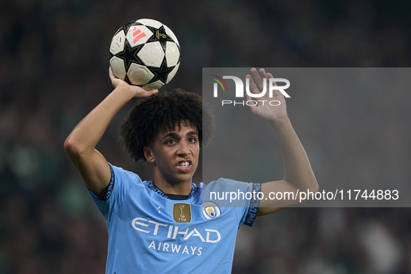 Rico Lewis of Manchester City takes a throw-in during the UEFA Champions League match between Sporting CP and Manchester City at Jose Alvala...