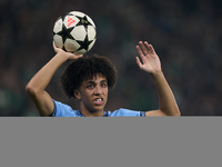 Rico Lewis of Manchester City takes a throw-in during the UEFA Champions League match between Sporting CP and Manchester City at Jose Alvala...