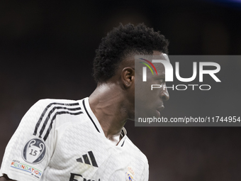 Vinicius Jr of Real Madrid plays during the UEFA Champions League 2024/25 match between Real Madrid and AC Milan at Santiago Bernabeu Stadiu...