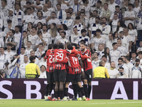 Several players of AC Milan celebrate a goal during the UEFA Champions League 2024/25 match between Real Madrid and AC Milan at Santiago Ber...