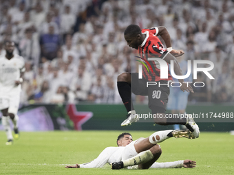 Jude Bellingham of Real Madrid and Yunus Musah of AC Milan fight for the ball during the UEFA Champions League 2024/25 match between Real Ma...