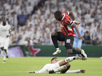 Jude Bellingham of Real Madrid and Yunus Musah of AC Milan fight for the ball during the UEFA Champions League 2024/25 match between Real Ma...