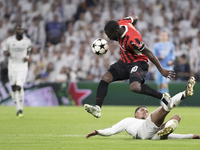 Jude Bellingham of Real Madrid and Yunus Musah of AC Milan fight for the ball during the UEFA Champions League 2024/25 match between Real Ma...