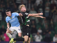 Phil Foden of Manchester City competes for the ball with Conrad Harder of Sporting CP during the UEFA Champions League match between Sportin...