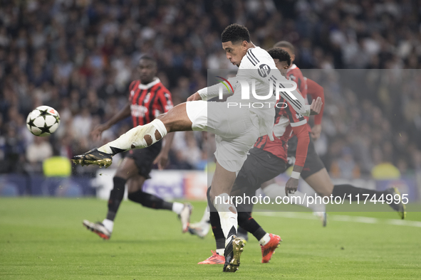 Jude Bellingham of Real Madrid attempts a shot during the UEFA Champions League 2024/25 match between Real Madrid and AC Milan at Santiago B...