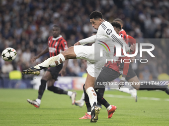 Jude Bellingham of Real Madrid attempts a shot during the UEFA Champions League 2024/25 match between Real Madrid and AC Milan at Santiago B...