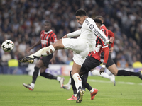 Jude Bellingham of Real Madrid attempts a shot during the UEFA Champions League 2024/25 match between Real Madrid and AC Milan at Santiago B...