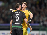 Franco Israel of Sporting CP celebrates victory with Zeno Debast after the UEFA Champions League match between Sporting CP and Manchester Ci...