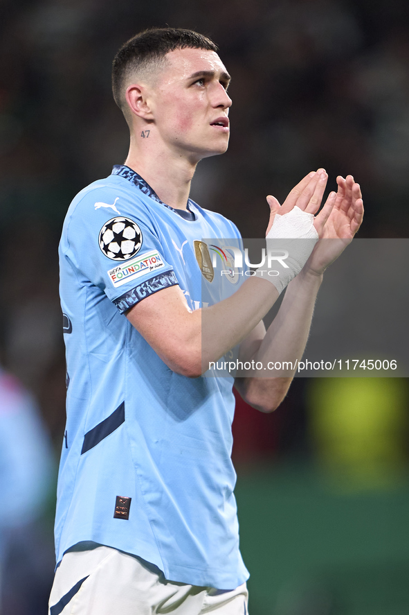 Phil Foden of Manchester City shows appreciation to the fans after the UEFA Champions League match between Sporting CP and Manchester City a...