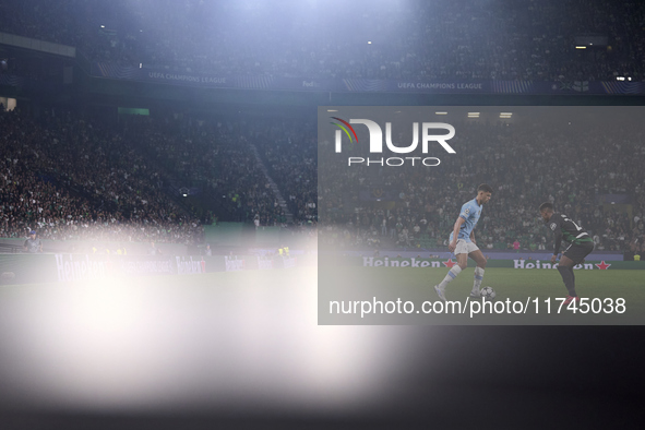 Matheus Nunes of Manchester City is challenged by Geny Catamo of Sporting CP during the UEFA Champions League match between Sporting CP and...