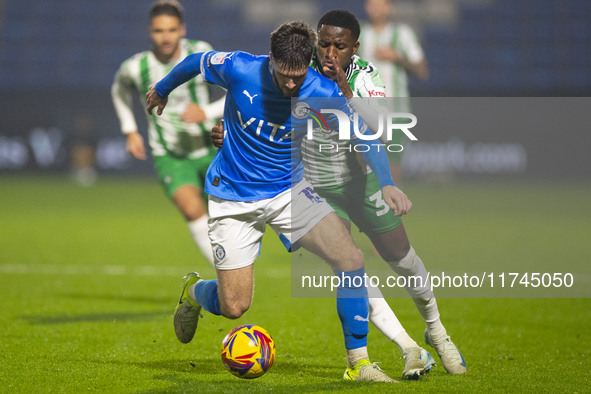 Ethan Pye #15 of Stockport County F.C. is tackled by Beryly Lubala #30 of Wycombe Wanderers F.C. during the Sky Bet League 1 match between S...