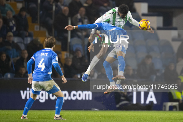 Odin Bailey #27 of Stockport County F.C. engages in an aerial challenge with an opponent during the Sky Bet League 1 match between Stockport...