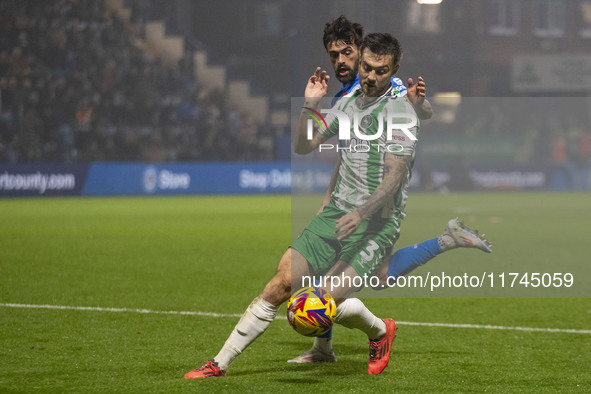 Daniel Harvie #3 of Wycombe Wanderers F.C. is tackled by an opponent during the Sky Bet League 1 match between Stockport County and Wycombe...