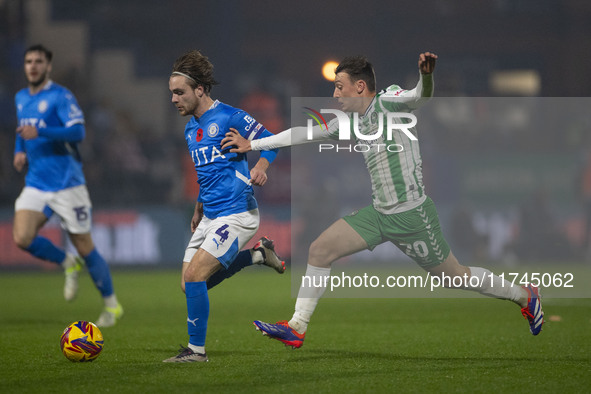 Lewis Bate, #4 of Stockport County F.C., is challenged by Cameron Humphreys, #20 of Wycombe Wanderers F.C., during the Sky Bet League 1 matc...