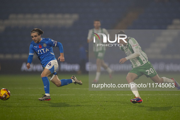 Lewis Bate #4 of Stockport County F.C. is challenged by Cameron Humphreys #20 of Wycombe Wanderers F.C. during the Sky Bet League 1 match be...