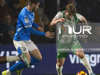 Jasper Pattenden, 31, of Wycombe Wanderers F.C. is tackled by the opponent during the Sky Bet League 1 match between Stockport County and Wy...