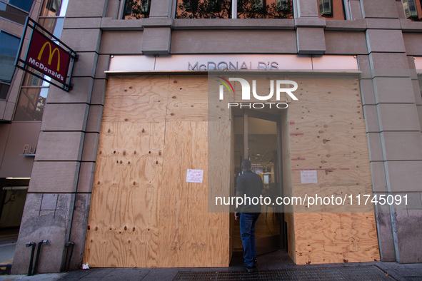 A man enters a McDonald's near the White House, which is boarded up in the event of violence following today's election for president in Was...