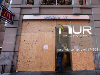 A man enters a McDonald's near the White House, which is boarded up in the event of violence following today's election for president in Was...