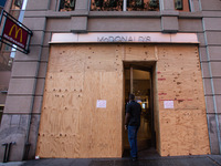 A man enters a McDonald's near the White House, which is boarded up in the event of violence following today's election for president in Was...