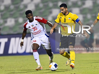 Seyed Mohammad Karimi of Asepahan SC battles for the ball with Ousmane Camar of Sharjah FC during the AFC Champions League Two Group A footb...