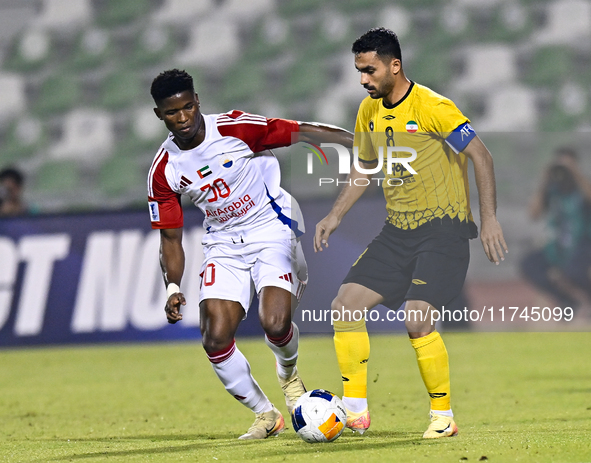 Seyed Mohammad Karimi of Asepahan SC battles for the ball with Ousmane Camar of Sharjah FC during the AFC Champions League Two Group A footb...