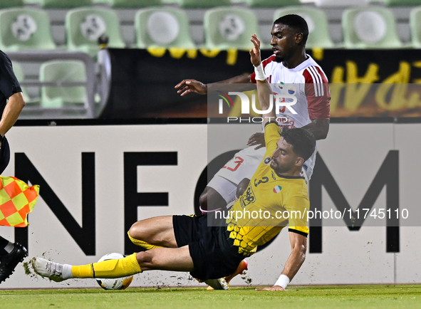 Hossein Goodarzi (bottom) of Sepahan SC battles for the ball with Tyrone Conraad of Sharjah FC during the AFC Champions League Two Group A f...