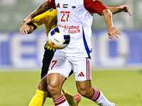 Seyed Mohammad Karimi of Asepahan SC battles for the ball with Guilherme Cunha of Sharjah FC during the AFC Champions League Two Group A foo...