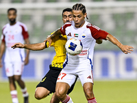 Seyed Mohammad Karimi of Asepahan SC battles for the ball with Guilherme Cunha of Sharjah FC during the AFC Champions League Two Group A foo...