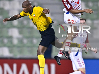 Bryan Dabo of Sepahan SC battles for the ball with Majid Rashid Almehrzi of Sharjah FC during the AFC Champions League Group A football matc...