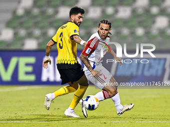 Hossein Goodarzi of Sepahan SC battles for the ball with Guilherme Cunha of Sharjah FC during the AFC Champions League Group A football matc...