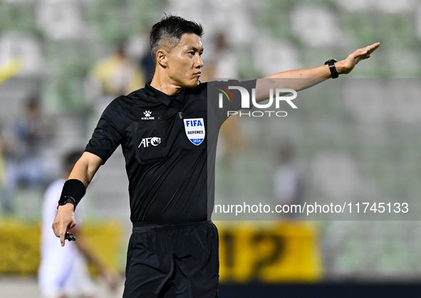 Chinese referee Shen Vinhao gestures during the AFC Champions League Two Group A football match between United Arab Emirates Sharjah FC and...