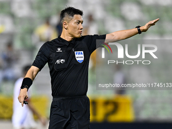 Chinese referee Shen Vinhao gestures during the AFC Champions League Two Group A football match between United Arab Emirates Sharjah FC and...