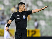 Chinese referee Shen Vinhao gestures during the AFC Champions League Two Group A football match between United Arab Emirates Sharjah FC and...