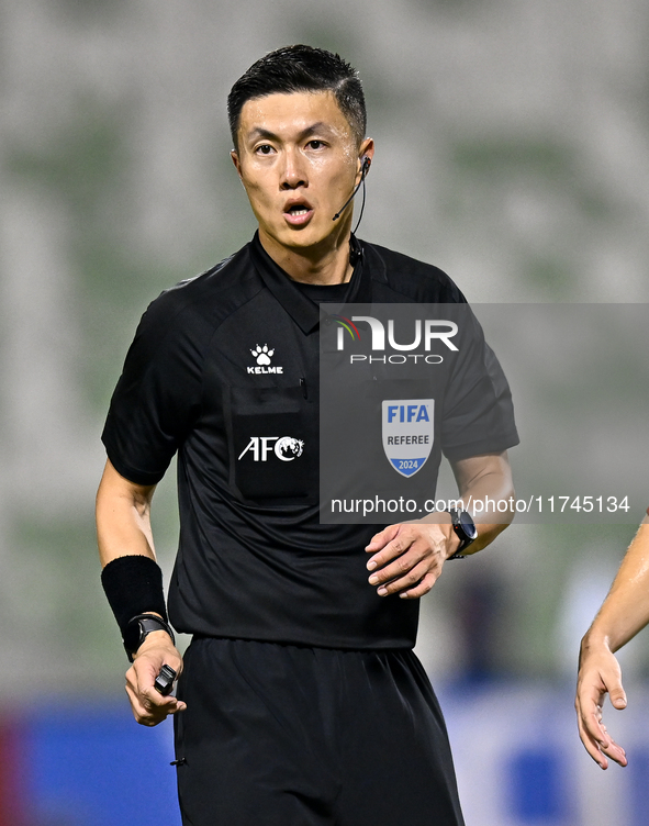 Chinese referee Shen Vinhao gestures during the AFC Champions League Two Group A football match between United Arab Emirates Sharjah FC and...