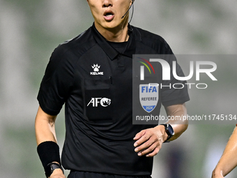 Chinese referee Shen Vinhao gestures during the AFC Champions League Two Group A football match between United Arab Emirates Sharjah FC and...