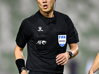 Chinese referee Shen Vinhao gestures during the AFC Champions League Two Group A football match between United Arab Emirates Sharjah FC and...