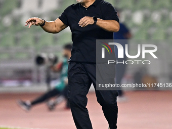 Sharjah FC head coach Aurelian Olaroiu reacts during the AFC Champions League Group A football match between United Arab Emirates' Sharjah F...