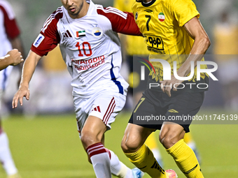 Mehdi Lamouchi of Sepahan SC battles for the ball with Mohamed Firas of Sharjah FC during the AFC Champions League Group A football match be...