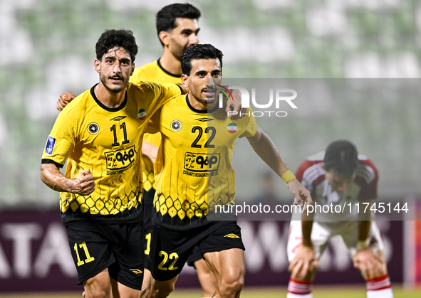 Javad Aghaeipour (L) of Sepahan SC celebrates with his teammates after scoring a goal during the AFC Champions League Group A football match...