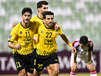 Javad Aghaeipour (L) of Sepahan SC celebrates with his teammates after scoring a goal during the AFC Champions League Group A football match...