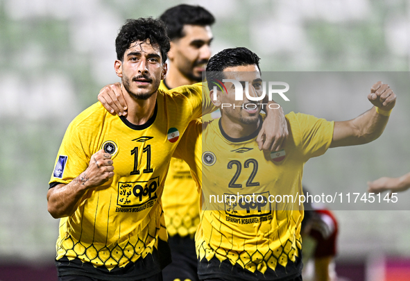 Javad Aghaeipour (L) of Sepahan SC celebrates with his teammates after scoring a goal during the AFC Champions League Group A football match...