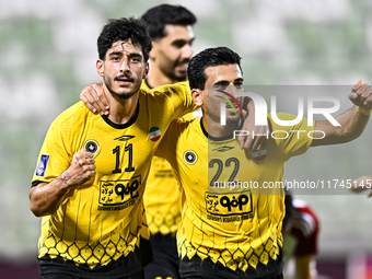 Javad Aghaeipour (L) of Sepahan SC celebrates with his teammates after scoring a goal during the AFC Champions League Group A football match...