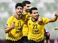 Javad Aghaeipour (L) of Sepahan SC celebrates with his teammates after scoring a goal during the AFC Champions League Group A football match...