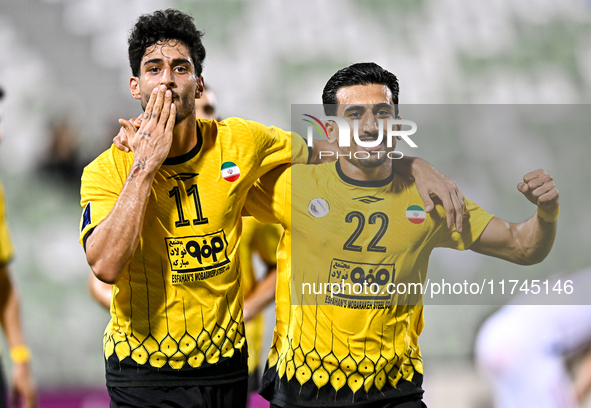 Javad Aghaeipour (L) of Sepahan SC celebrates with his teammates after scoring a goal during the AFC Champions League Group A football match...