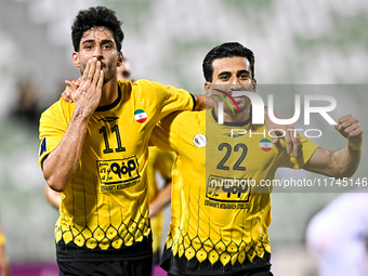 Javad Aghaeipour (L) of Sepahan SC celebrates with his teammates after scoring a goal during the AFC Champions League Group A football match...