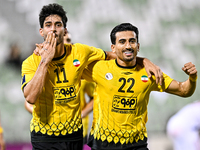 Javad Aghaeipour (L) of Sepahan SC celebrates with his teammates after scoring a goal during the AFC Champions League Group A football match...