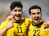 Javad Aghaeipour (L) of Sepahan SC celebrates with his teammates after scoring a goal during the AFC Champions League Group A football match...