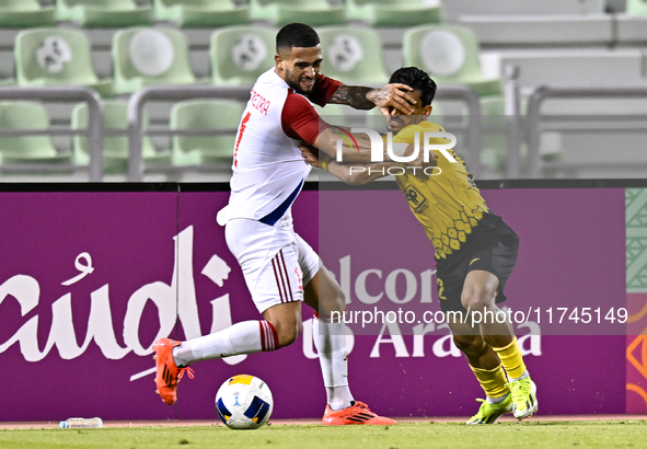 Saleh Hardani of Sepahan SC battles for the ball with Luan Pereira of Sharjah FC during the AFC Champions League Group A football match betw...